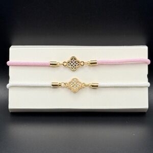 Set of 2 Clover Charm Bracelets Gold Tone Adjustable Pink White Cord